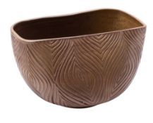 A stoneware bowl, of compressed circular form the exterior incised with a peacock feather design,