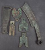 Six pieces of Chinese currency including Knife and spade money contained in an old Hong Kong and