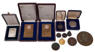 A small collection of various medallions and commemorative plaques,