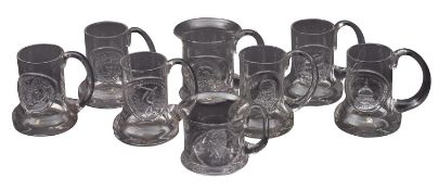 A collection of Dartington Glass commemorative tankards.
