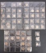 Three sheets of mainly silver world coins.