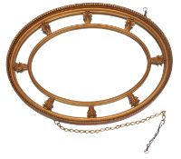 A giltwood oval marginal wall mirror,