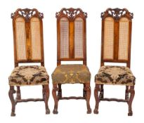 A set of three carved walnut dining chairs in William and Mary style,