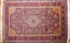 A Kashmiri rug, the indigo field with a central ivory circular medallion,