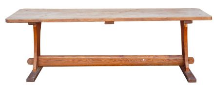 An Oregon pine trestle table, 20th century; the rectangular top with rounded corners,
