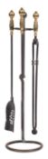 A set of three steel and brass fire irons, with companion stand, 20th century; comprising shovel,
