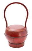 A Chinese red lacquered food basket with high loop handle,