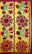 A North East Persian silk embroidered bed cover worked with a design of vases of flowers and