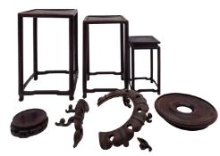 A set of three Chinese graduated wood upright display stands and three other stands [damages].