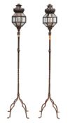 A pair of wrought iron standard lanterns;