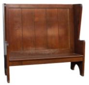 An Arts & Crafts oak settle, in 17th-century style,