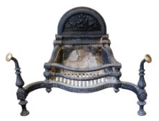 A Victorian cast iron and brass mounted firegrate, late 19th century; of serpentine outline,