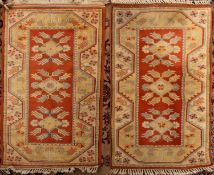 Four matching Melas rugs,