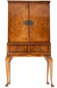 A burr walnut veneer cocktail cabinet, in early 18th century style,