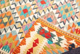 An Anatolian Turkish Kelim, the field with serrated lozenge medallions in multiple bright colours,