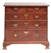 A mid 18th-century mahogany rectangular chest; the top with a moulded edge and rounded corners,