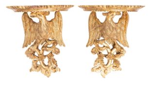 A pair of carved and giltwood wall brackets in 18th century taste,