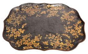 A Victorian parcel gilt black papier-mâché tray, mid 19th century; of cartouche form,