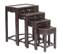 A nest of four Chinese carved and stained hardwood occasional tables,