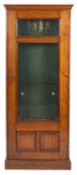 A Victorian oak and glazed gun cabinet, late 19th century; with moulded cornice above the door,