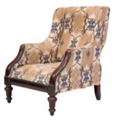 A George IV mahogany and upholstered wing armchair, circa 1825; the arms with showframe fascias,