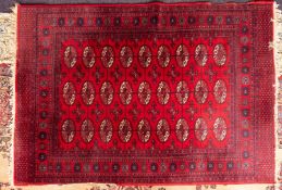 A machine made rug of Turkoman design,