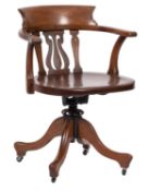 A late Victorian walnut swivel desk office armchair;
