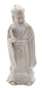A Chinese blanc-de-chine figure of Shou-Lao wearing flowing robes and holding a scroll,