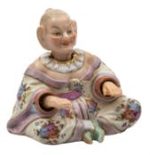 A small Continental porcelain pagoda figure the seated chinaman with nodding head and arms,