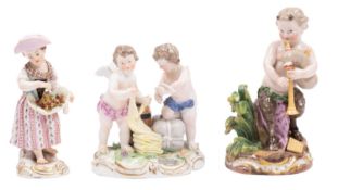 A group of three Meissen figures comprising an 18th Century group of cherub traders with bolts of