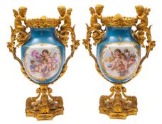 A pair of 19th century French ormolu-mounted porcelain urns decorated in the Sevres manner with