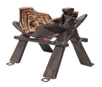 A Near Eastern stained wood and metal mounted camel saddle frame,
