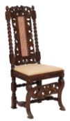 A late 19th-century carved oak chair in Charles II style;