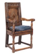 A 17th-century oak Wainscot armchair, probably Exeter; the back with fluted top rail lozenge,