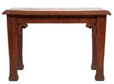 A Gothic revival oak low table; the three-piece rectangular top with ovolo moulded edges,