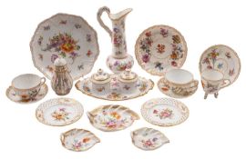 A collection of Dresden porcelain painted with floral sprays within gilt borders,