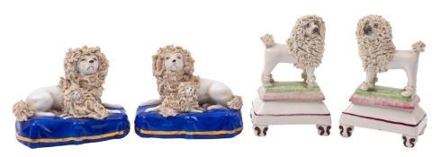 A pair of 19th century Staffordshire pottery miniature models of poodles and a similar pair of