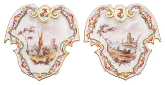 A pair of French faience wall plaques of cartouche form,