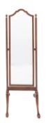 An Edwardian mahogany swing frame cheval mirror; with an arched plate,