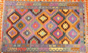An Anatolian Turkish Kelim, the serrated lozenge field with bright multiple colours,