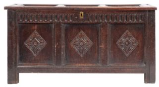 A late 17th-century oak rectangular coffer; with a plain triple panelled hinged top,
