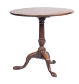 A George III mahogany circular tea table;