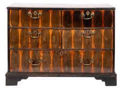 A George II oyster laburnum chest of drawers; the inlaid top above four short and one long drawer,