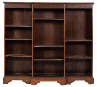 An Edwardian oak low open breakfront bookcase;