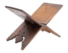 A New Guinea folding hardwood table stand; carved with roundels within chip carved borders;