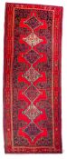 A Senneh Kelleh, the red field with a row of stepped and pointed lozenge medallions,