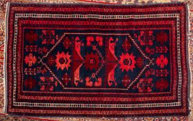 A Balouchistan rug, the indigo hexagonal stepped field with geometric foliate and stellar designs,