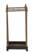 An Edwardian brass six division umbrella stand, with urn finials,