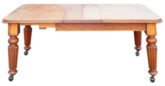 A Victorian mahogany extending dining table with a telescopic action; the top with rounded corners,