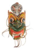 A South East Asian carved and painted wood mask;
